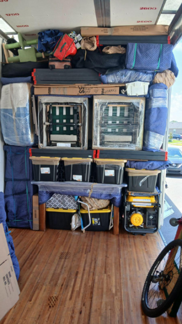 Close-up of moving blankets and boxes loaded for transport
