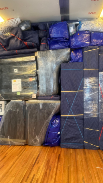 Close-up of moving blankets and boxes loaded for transport